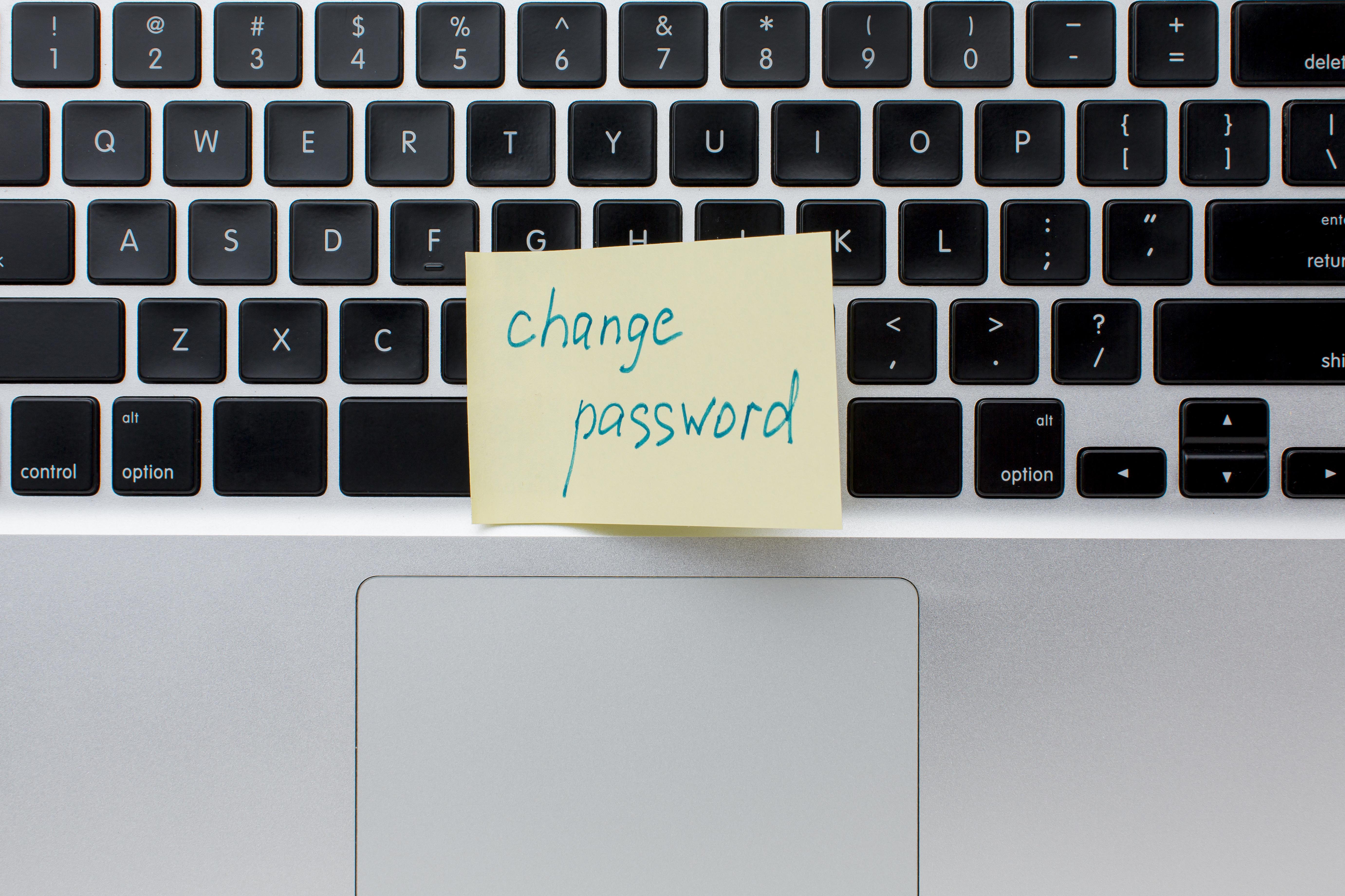 Password manager comparison showing Bitwarden 1Password Dashlane on laptop screen with security checklist - how to fix password fatigue 2025